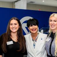 President Mantella standing between two young women, smiling for camera